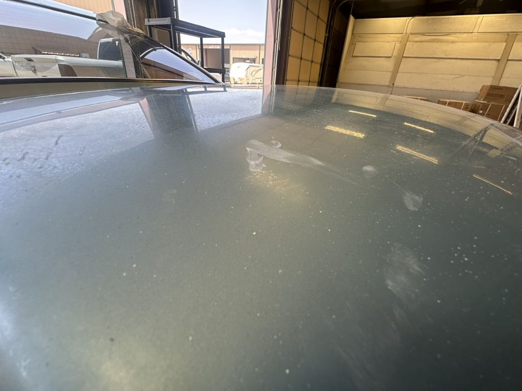 Close view of the 280Z roof before service showing scuffs, chips and dull paint