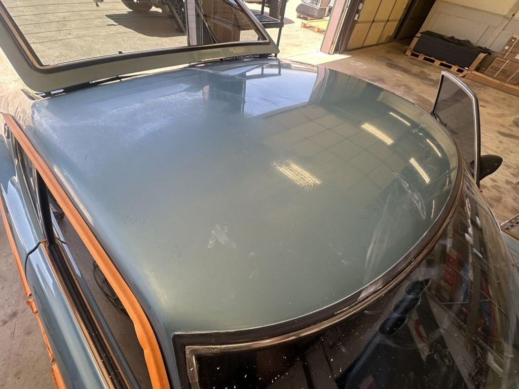 Roof of the 1977 Datsun 280Z before service: faded, chalky paint with water etching