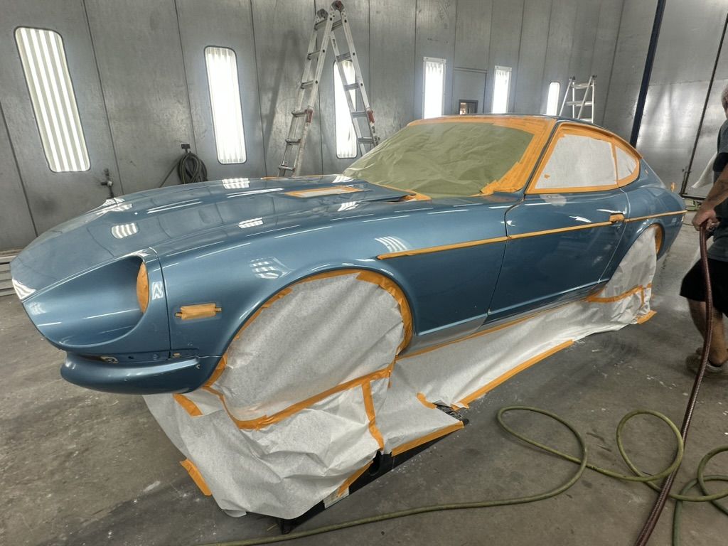 1977 Datsun 280Z masked in the Patriots RV paint booth after spraying, glass and wheels covered