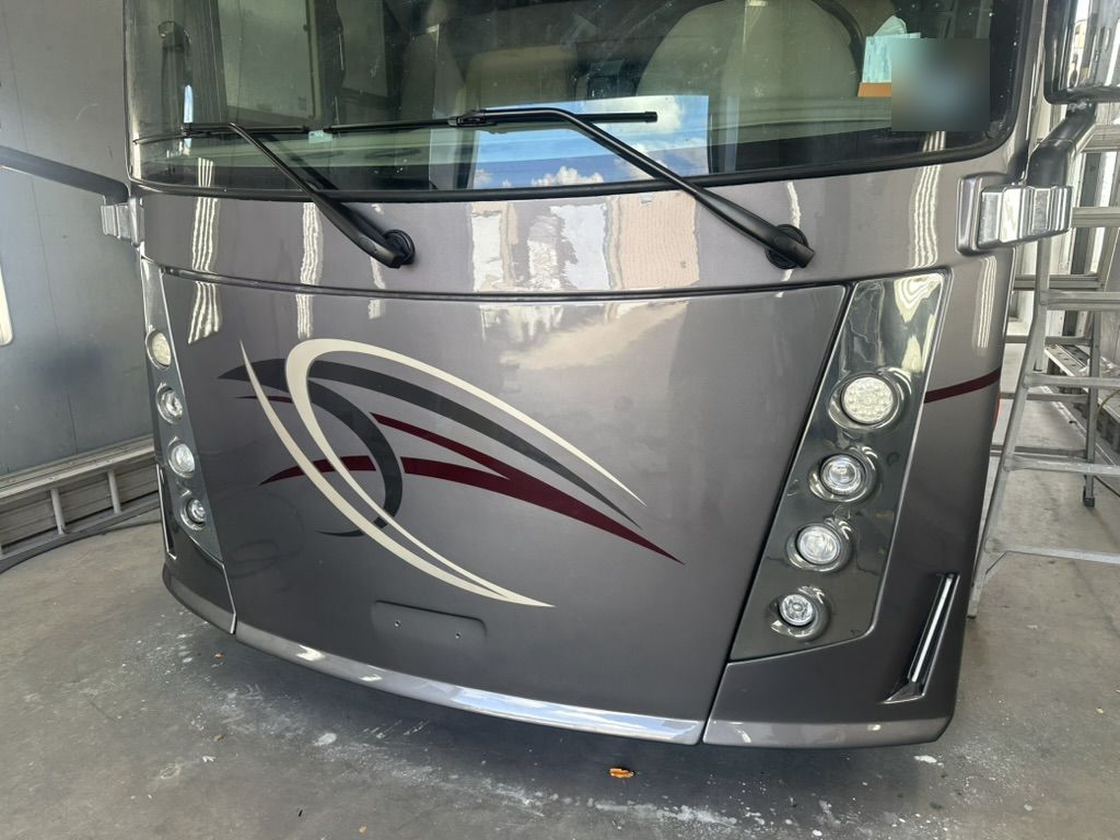 Finished Class A motorhome front cap in gloss gray with burgundy and cream graphics, AeroArmor Paint Shield, Krum, Texas