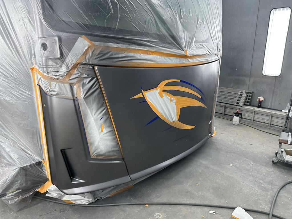 Curved motorhome front cap masked and sprayed in the Patriots RV paint booth
