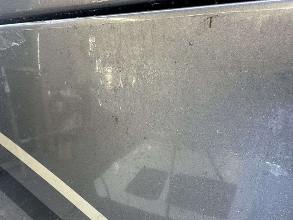 Adhesive haze and film outline left on a motorhome front cap panel