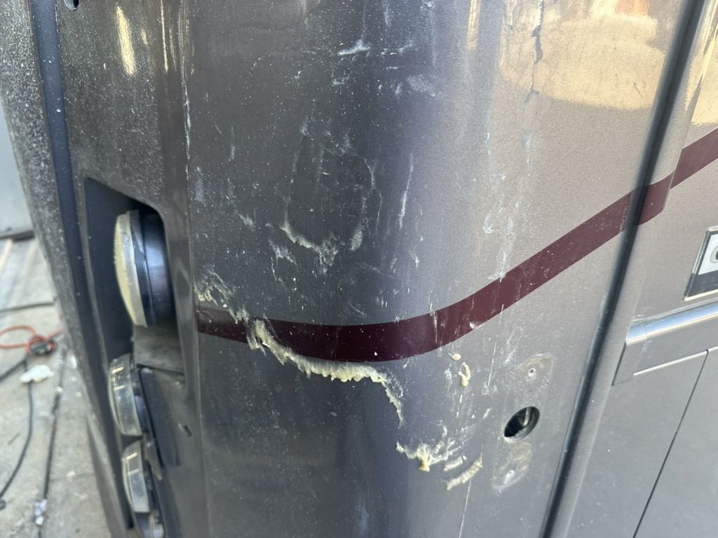 Sticky adhesive residue around the front corner lights of a motorhome after Diamond Shield removal