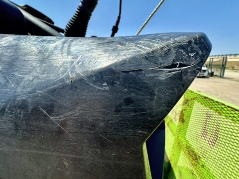 Deep scratches and a gouge in the UTV body before service