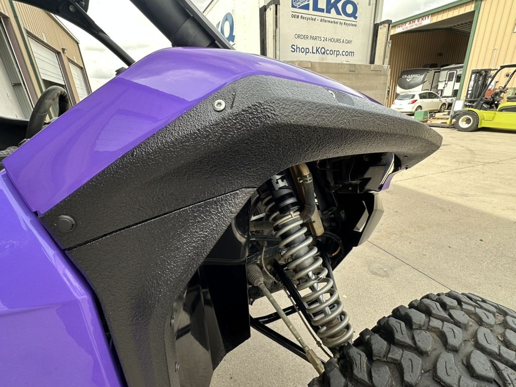 Front fender of the purple Teryx KRX with textured black flare and glossy purple panel