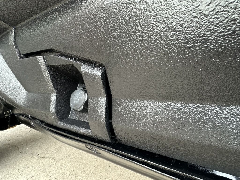 Close-up of the textured black protective coating on the UTV rocker panel