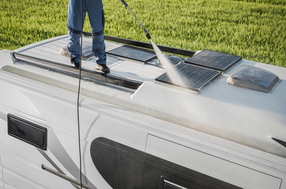 rv-industry-worker-cleaning-camper-van-roof-motorhome-solar-panels_1426-6431-transformed