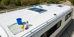A motorhome roof with cleaning supplies ready for the sealing process.