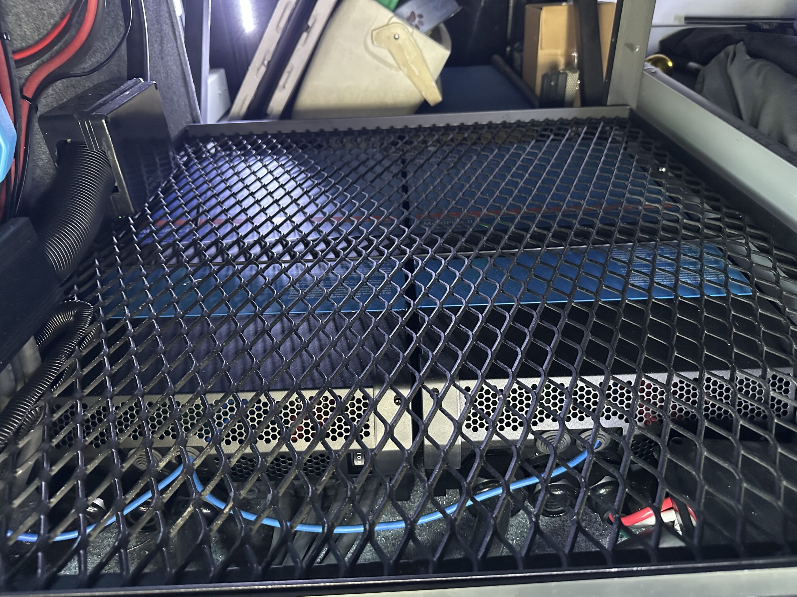 Custom ventilation rack over Victron Lynx inverter system in RV compartment